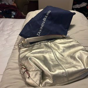 A large silver Dooney and Bourke bag….only worn twice.